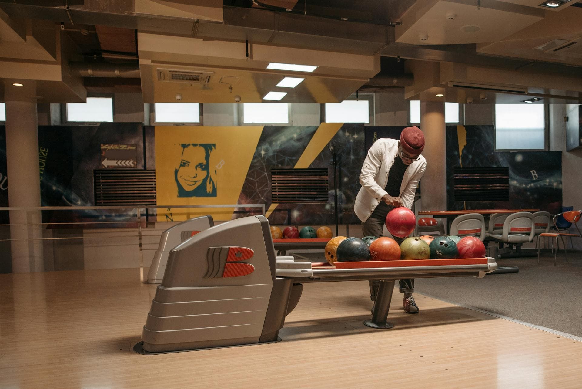 Bowler selecting a ball from the rack