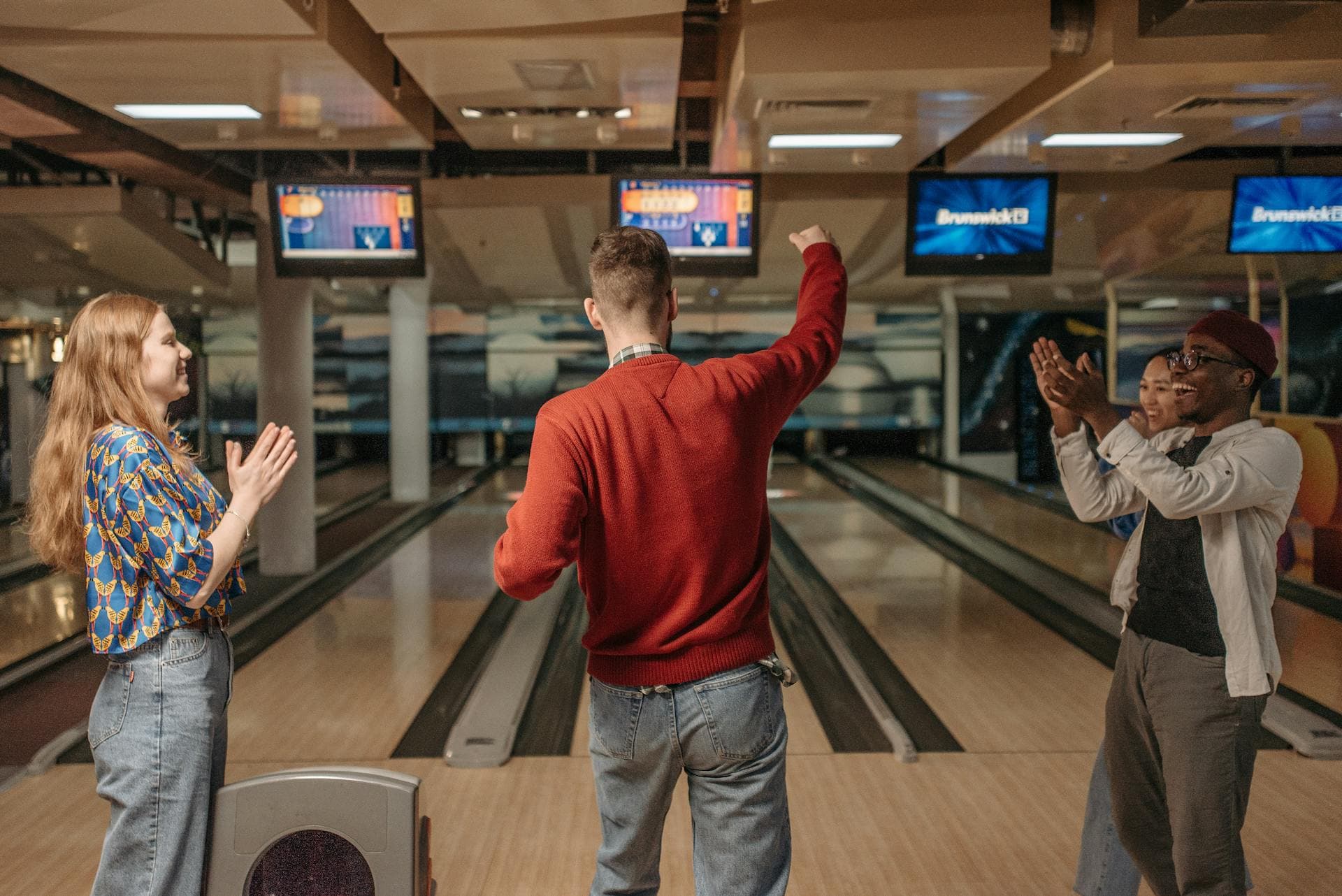 Friends celebrating a strike at Rolling Meadow Lanes