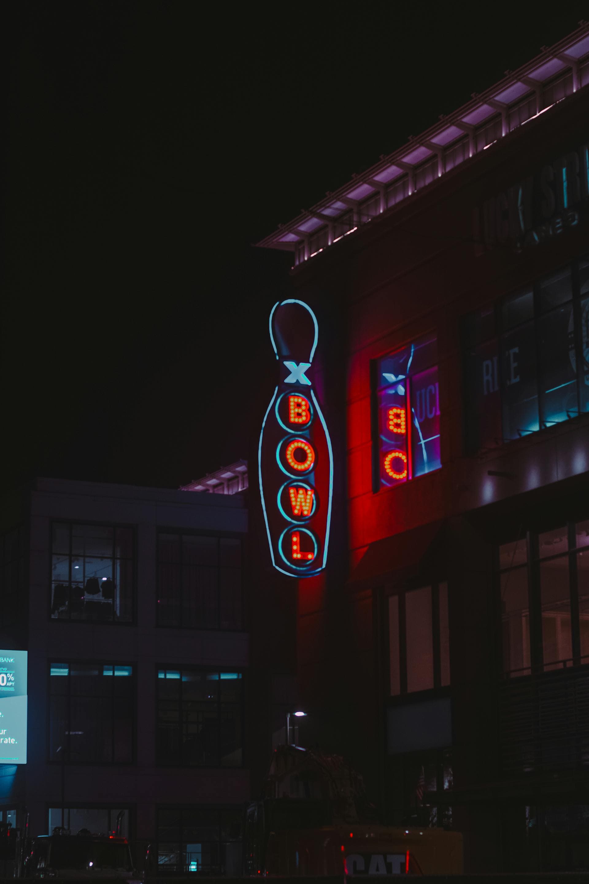 Neon bowling sign lit up at night