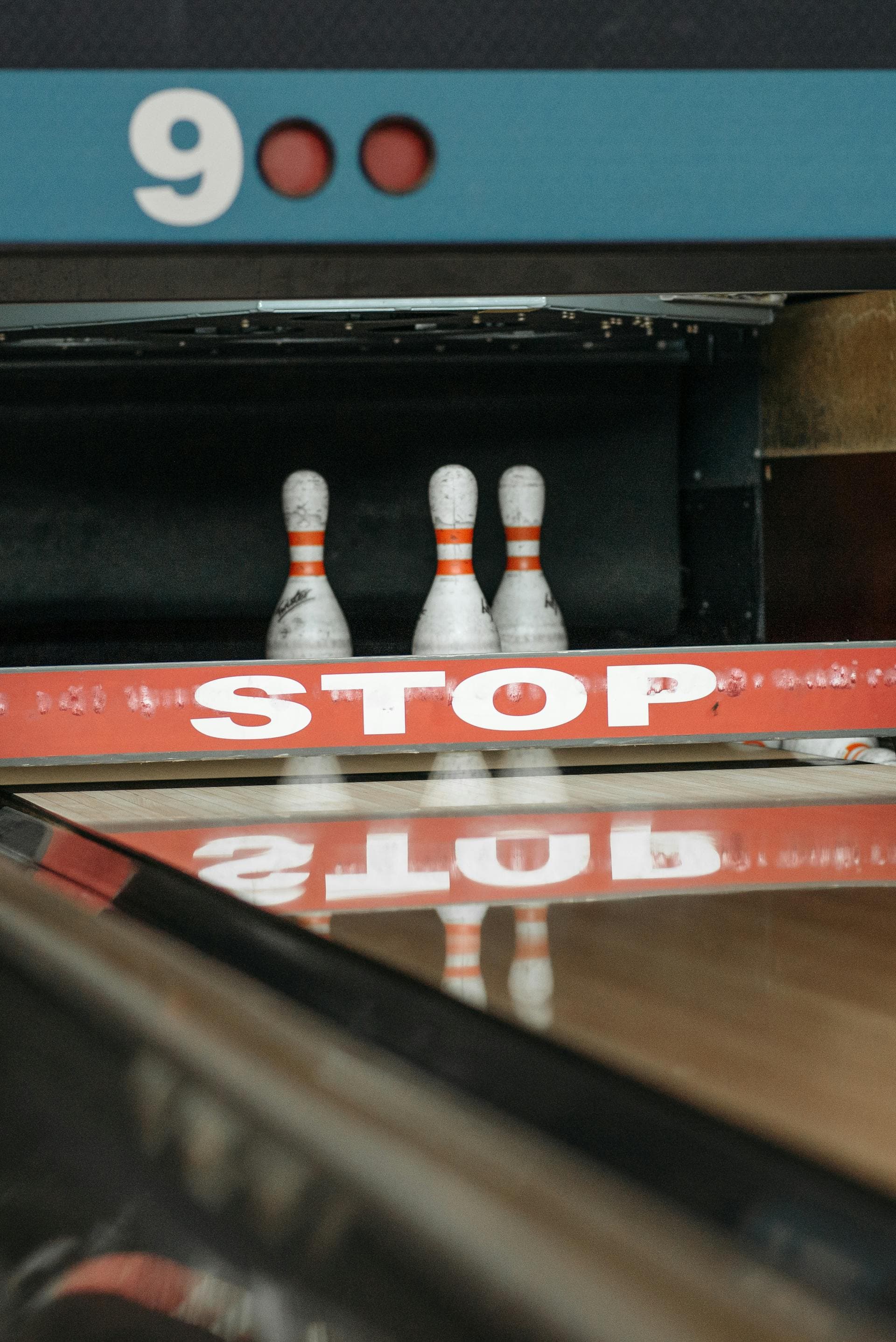 Pins behind the STOP bar at the end of the lane